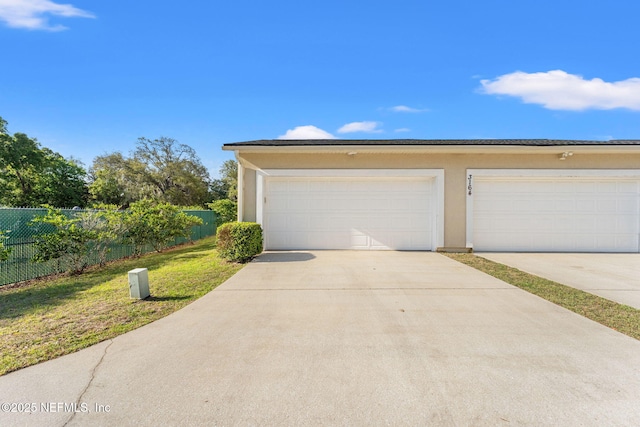 3164 Ravines Rd, Middleburg, FL 32068 - view of front of home with stucco siding, driveway, and a garage