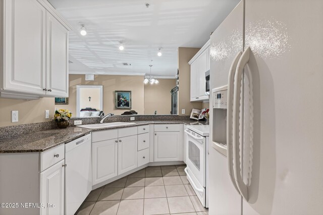 160 Legendary Dr Unit 204, Saint Augustine, FL 32092 - kitchen with white appliances, light tile patterned floors, white cabinets, and ornamental molding