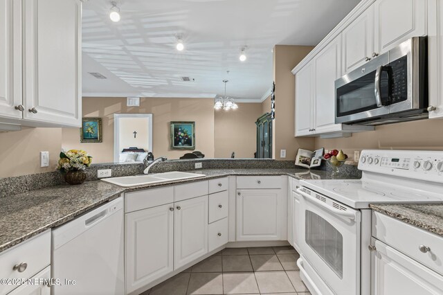 160 Legendary Dr Unit 204, Saint Augustine, FL 32092 - kitchen with white appliances, ornamental molding, light tile patterned flooring, white cabinets, and dark stone counters