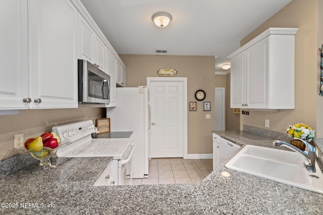 160 Legendary Dr Unit 204, Saint Augustine, FL 32092 - kitchen featuring white appliances, light tile patterned floors, and white cabinetry