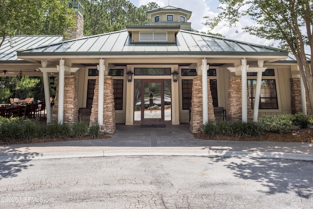 1356 Barrington Cir, Saint Augustine, FL 32092 - property entrance featuring a standing seam roof, stone siding, and a metal roof