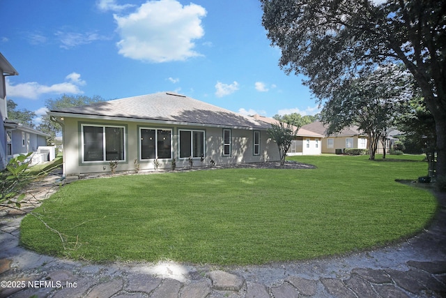1356 Barrington Cir, Saint Augustine, FL 32092 - back of property featuring roof with shingles, a yard, and stucco siding