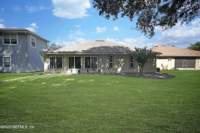 1356 Barrington Cir, Saint Augustine, FL 32092 - rear view of house with a lawn, stucco siding, a sunroom, and roof with shingles