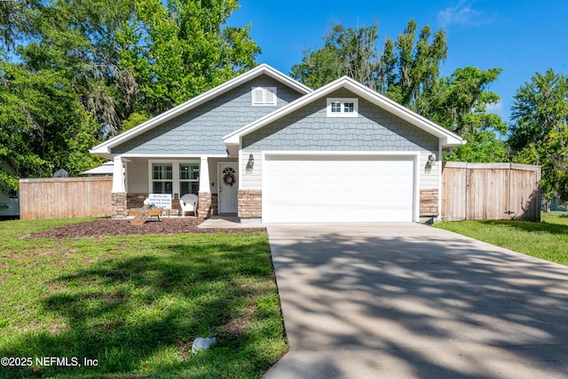 210 N Saint Clair St, Starke, FL 32091 - craftsman inspired home with a garage, concrete driveway, and stone siding
