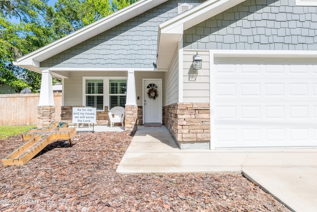 210 N Saint Clair St, Starke, FL 32091 - entrance to property featuring a garage, stone siding, and driveway