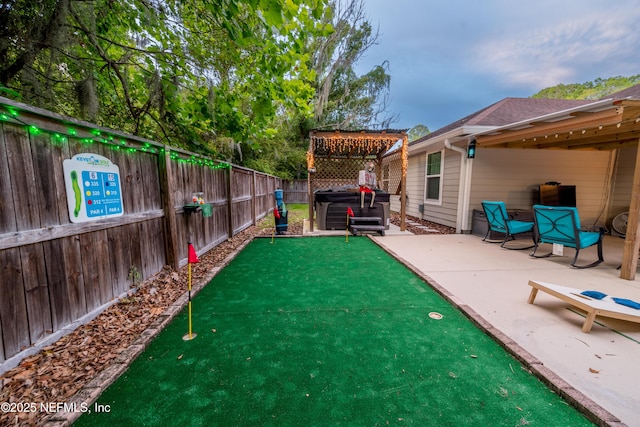 210 N Saint Clair St, Starke, FL 32091 - fenced backyard with a putting area, a patio area, and a pergola