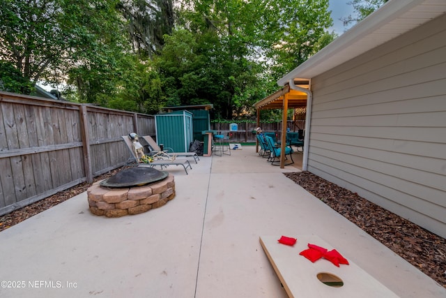 210 N Saint Clair St, Starke, FL 32091 - fenced backyard with a fire pit, a patio area, and a shed