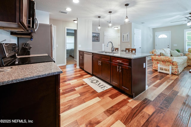 210 N Saint Clair St, Starke, FL 32091 - kitchen featuring stainless steel appliances, a ceiling fan, light wood finished floors, open floor plan, and recessed lighting