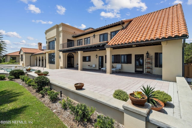 1185 Ponte Vedra Blvd, Ponte Vedra Beach, FL 32082 - rear view of property with a balcony, stucco siding, a patio area, and a tile roof