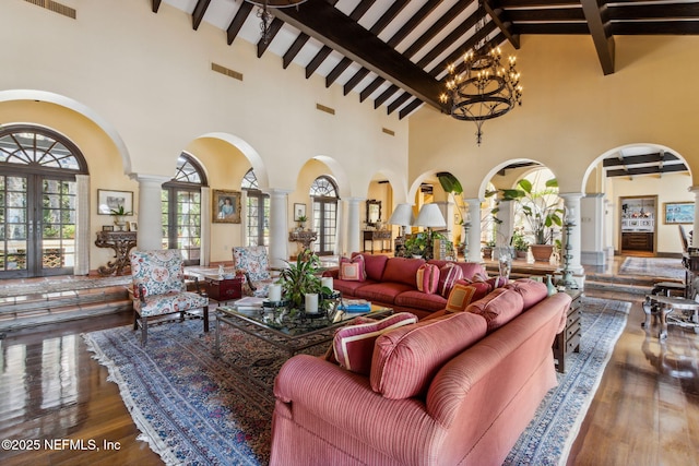 1185 Ponte Vedra Blvd, Ponte Vedra Beach, FL 32082 - living room featuring ornate columns, high vaulted ceiling, arched walkways, beamed ceiling, and hardwood / wood-style flooring
