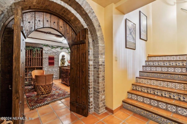 1185 Ponte Vedra Blvd, Ponte Vedra Beach, FL 32082 - wine room with arched walkways, brick wall, and tile patterned floors