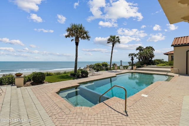 1185 Ponte Vedra Blvd, Ponte Vedra Beach, FL 32082 - view of swimming pool featuring a patio area, a pool with connected hot tub, and a water view