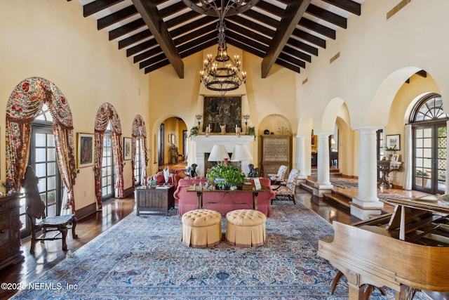 1185 Ponte Vedra Blvd, Ponte Vedra Beach, FL 32082 - living room with high vaulted ceiling, a chandelier, beamed ceiling, wood finished floors, and ornate columns