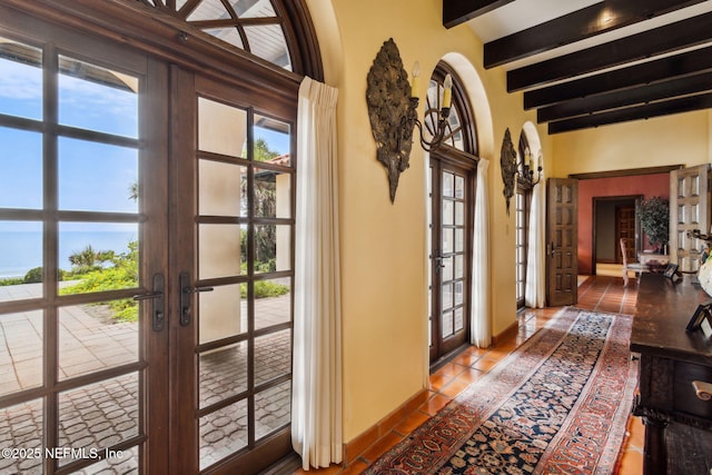 1185 Ponte Vedra Blvd, Ponte Vedra Beach, FL 32082 - tiled foyer entrance featuring french doors, beam ceiling, plenty of natural light, and arched walkways