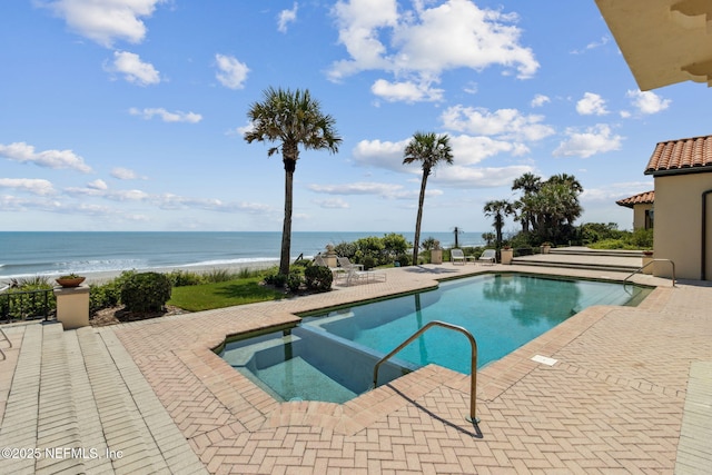 1185 Ponte Vedra Blvd, Ponte Vedra Beach, FL 32082 - view of swimming pool featuring a patio area, a pool with connected hot tub, and a water view