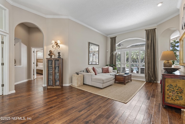 312 Bartram Trl, Saint Johns, FL 32259 - living room with arched walkways, dark wood-style flooring, ornamental molding, and a textured ceiling