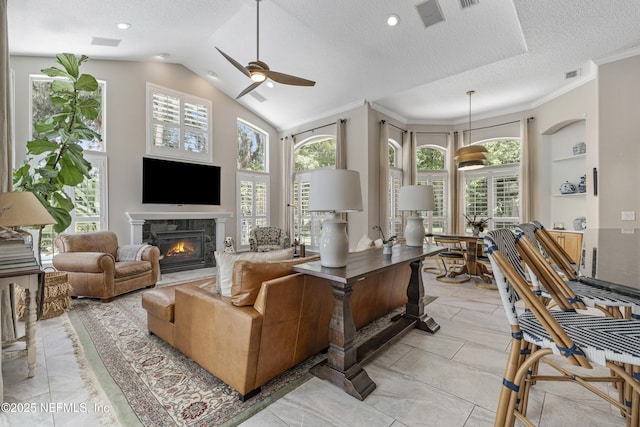 312 Bartram Trl, Saint Johns, FL 32259 - living area with ceiling fan, plenty of natural light, a high end fireplace, lofted ceiling, and a textured ceiling