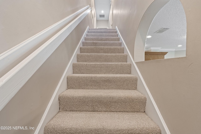 312 Bartram Trl, Saint Johns, FL 32259 - staircase featuring arched walkways and a textured ceiling