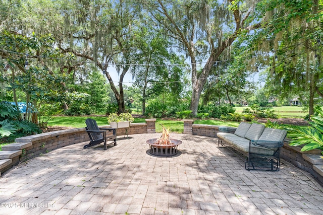 312 Bartram Trl, Saint Johns, FL 32259 - view of patio / terrace featuring an outdoor fire pit and view of wooded area