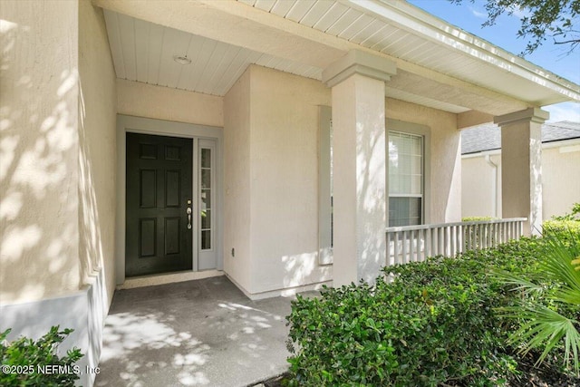 336 Edge Of Woods Rd, Saint Augustine, FL 32092 - view of exterior entry with stucco siding and covered porch