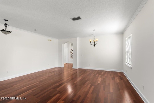 336 Edge Of Woods Rd, Saint Augustine, FL 32092 - spare room with arched walkways, a chandelier, dark wood-style flooring, a textured ceiling, and ornamental molding