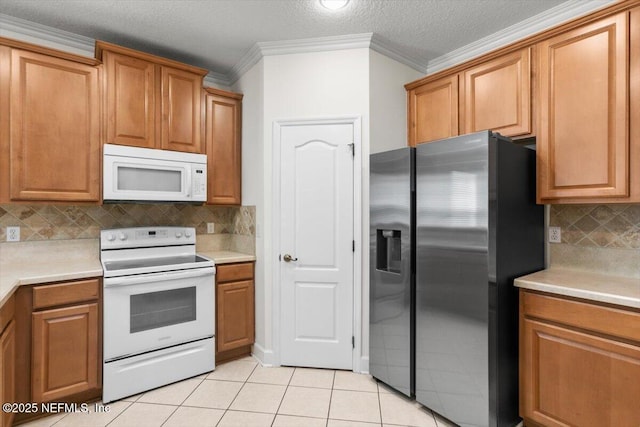 336 Edge Of Woods Rd, Saint Augustine, FL 32092 - kitchen with white appliances, tasteful backsplash, light countertops, crown molding, and light tile patterned floors