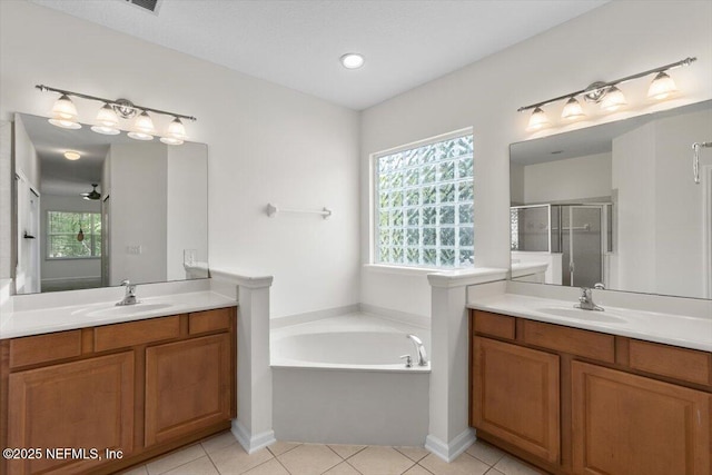 336 Edge Of Woods Rd, Saint Augustine, FL 32092 - full bath featuring a stall shower, two vanities, a garden tub, and tile patterned flooring