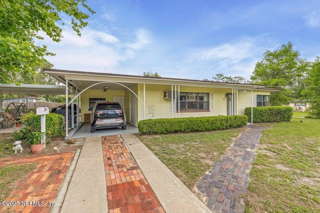 2305 Broward Rd, Jacksonville, FL 32218 - view of front facade featuring an attached carport, driveway, and a front yard