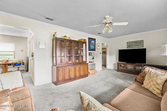 2305 Broward Rd, Jacksonville, FL 32218 - living area with light carpet, ornamental molding, a ceiling fan, and arched walkways