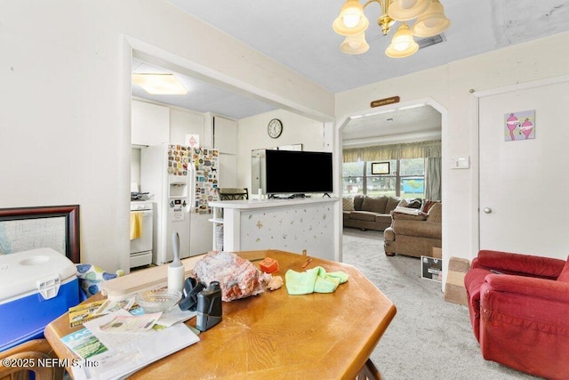 2305 Broward Rd, Jacksonville, FL 32218 - dining space with light colored carpet, a chandelier, and arched walkways
