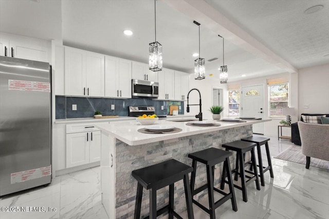 8940 Monroe Ave, Jacksonville, FL 32208 - kitchen with stainless steel appliances, light marble finish floors, backsplash, recessed lighting, and white cabinets