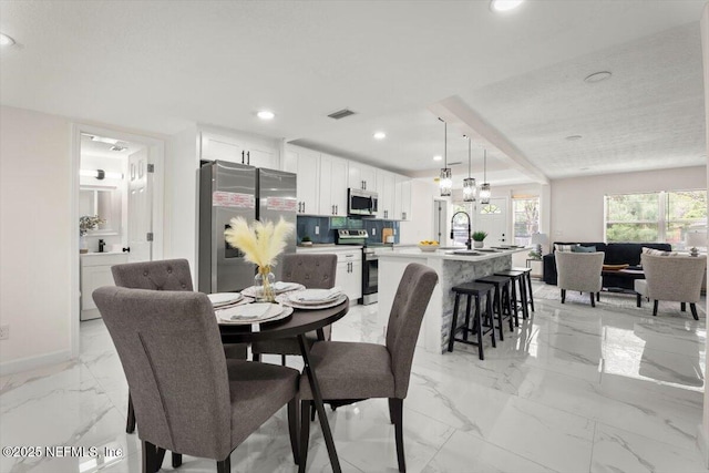 8940 Monroe Ave, Jacksonville, FL 32208 - dining area featuring light marble finish floors and recessed lighting