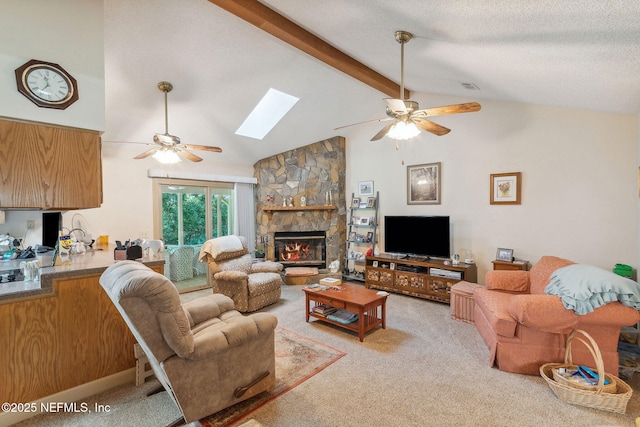 835 Fountain Dr, Fernandina Beach, FL 32034 - living room with a ceiling fan, beam ceiling, a stone fireplace, light carpet, and a skylight