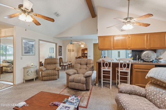 835 Fountain Dr, Fernandina Beach, FL 32034 - living room with a ceiling fan, light colored carpet, beamed ceiling, and high vaulted ceiling