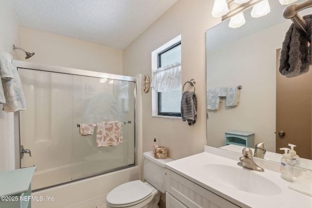 835 Fountain Dr, Fernandina Beach, FL 32034 - full bath with vanity, bath / shower combo with glass door, and a textured ceiling