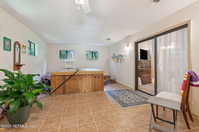 835 Fountain Dr, Fernandina Beach, FL 32034 - kitchen featuring a textured ceiling, light tile patterned floors, light countertops, and brown cabinetry