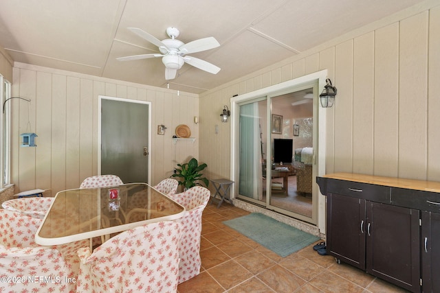 835 Fountain Dr, Fernandina Beach, FL 32034 - dining room with a ceiling fan, light tile patterned floors, and wood walls