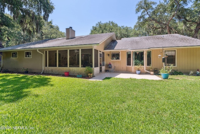 835 Fountain Dr, Fernandina Beach, FL 32034 - back of property featuring a chimney, a patio, a yard, and a shingled roof