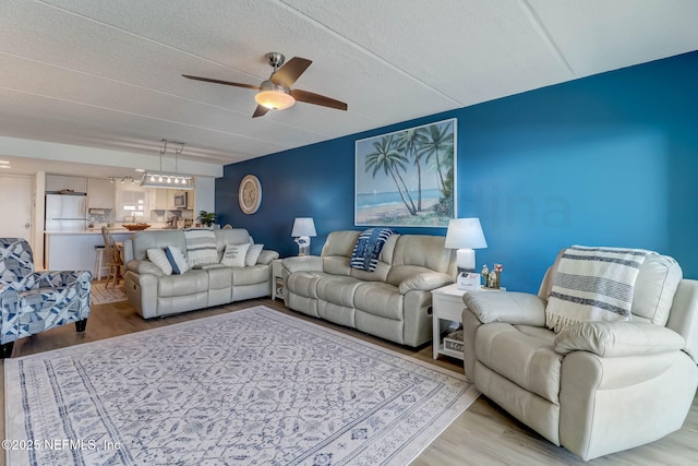 3350 S Fletcher Ave Unit C5, Fernandina Beach, FL 32034 - living area featuring light wood-style floors, ceiling fan, and a textured ceiling
