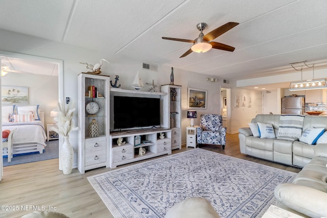 3350 S Fletcher Ave Unit C5, Fernandina Beach, FL 32034 - living room featuring a ceiling fan, light wood finished floors, and a textured ceiling