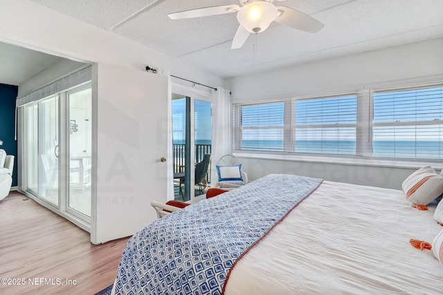3350 S Fletcher Ave Unit C5, Fernandina Beach, FL 32034 - bedroom featuring access to outside, wood finished floors, a ceiling fan, and a textured ceiling