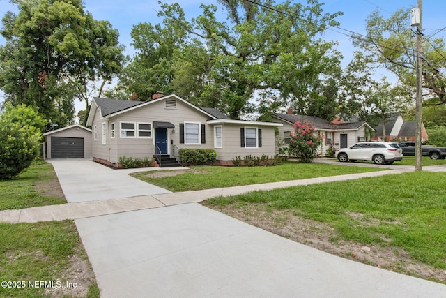 4723 Sunderland Rd, Jacksonville, FL 32210 - view of front facade featuring driveway, an outdoor structure, entry steps, a front yard, and a detached garage