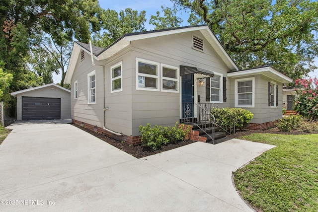 4723 Sunderland Rd, Jacksonville, FL 32210 - view of front of house with an outbuilding, a detached garage, and concrete driveway