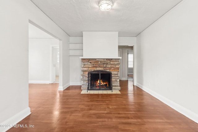 4723 Sunderland Rd, Jacksonville, FL 32210 - unfurnished living room with a fireplace, wood finished floors, and built in shelves