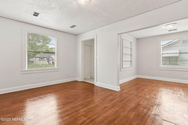 4723 Sunderland Rd, Jacksonville, FL 32210 - empty room with wood finished floors and a textured ceiling