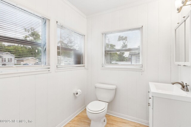 4723 Sunderland Rd, Jacksonville, FL 32210 - bathroom with vanity, wood finished floors, crown molding, and healthy amount of natural light
