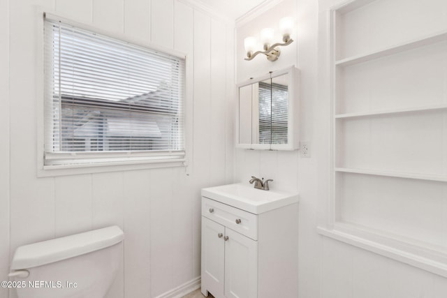 4723 Sunderland Rd, Jacksonville, FL 32210 - half bath featuring vanity, crown molding, and built in shelves