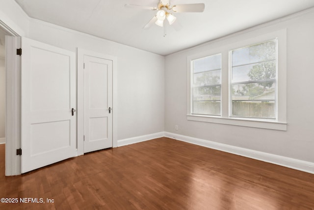 4723 Sunderland Rd, Jacksonville, FL 32210 - unfurnished bedroom featuring dark wood finished floors, crown molding, and a ceiling fan