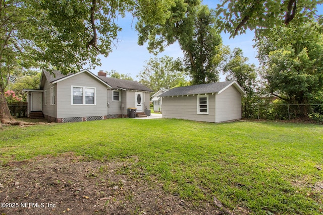 4723 Sunderland Rd, Jacksonville, FL 32210 - rear view of house with an outbuilding, a chimney, and entry steps