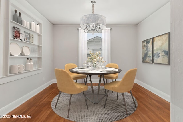 4723 Sunderland Rd, Jacksonville, FL 32210 - dining room featuring wood finished floors and a chandelier